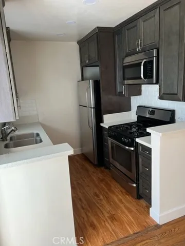a kitchen with a stove microwave and refrigerator