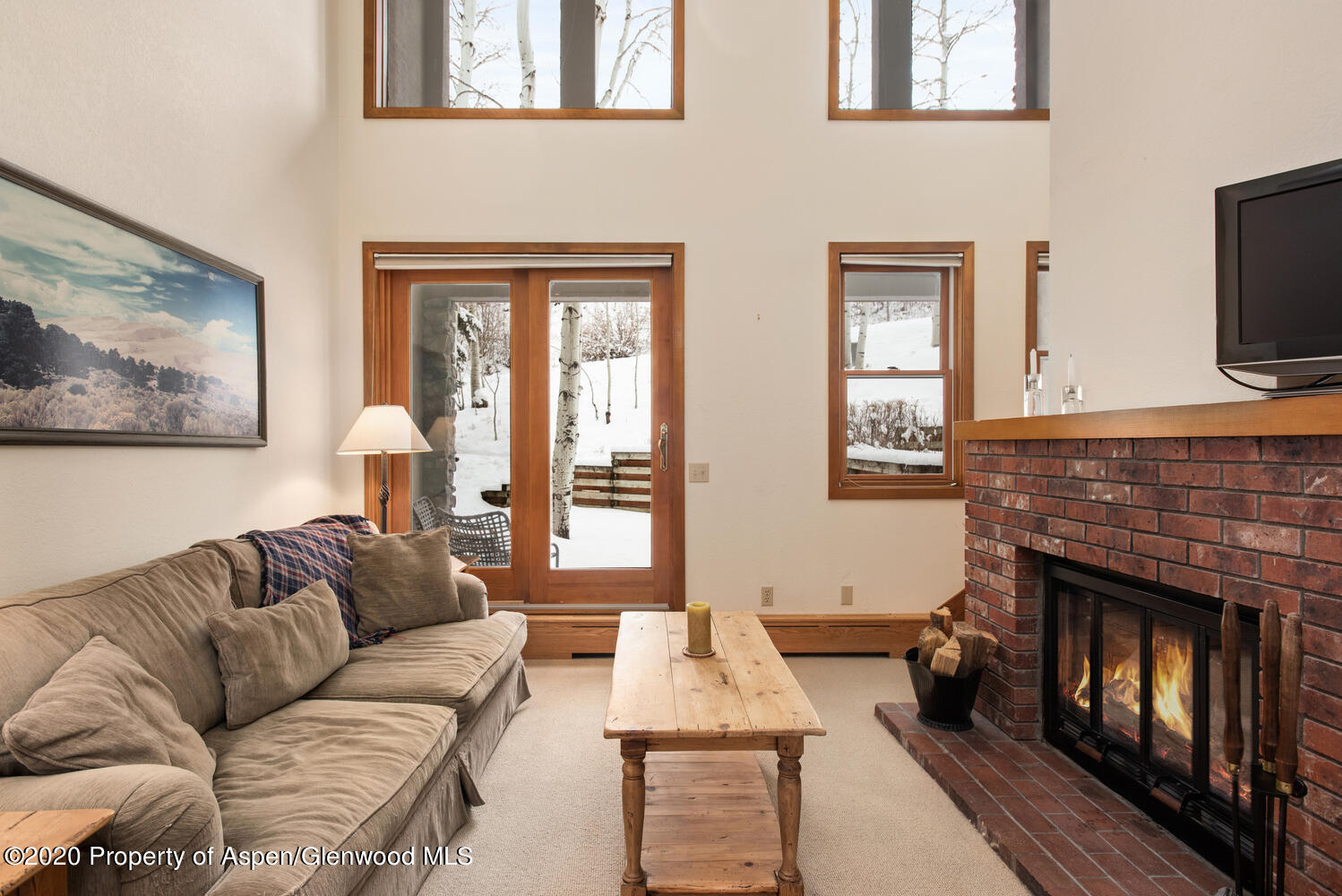 425 Wood Road, Unit 6 Snowmass Village, CO 81615 - Photo 1 of 16 a living room with furniture a flat screen tv and a fireplace