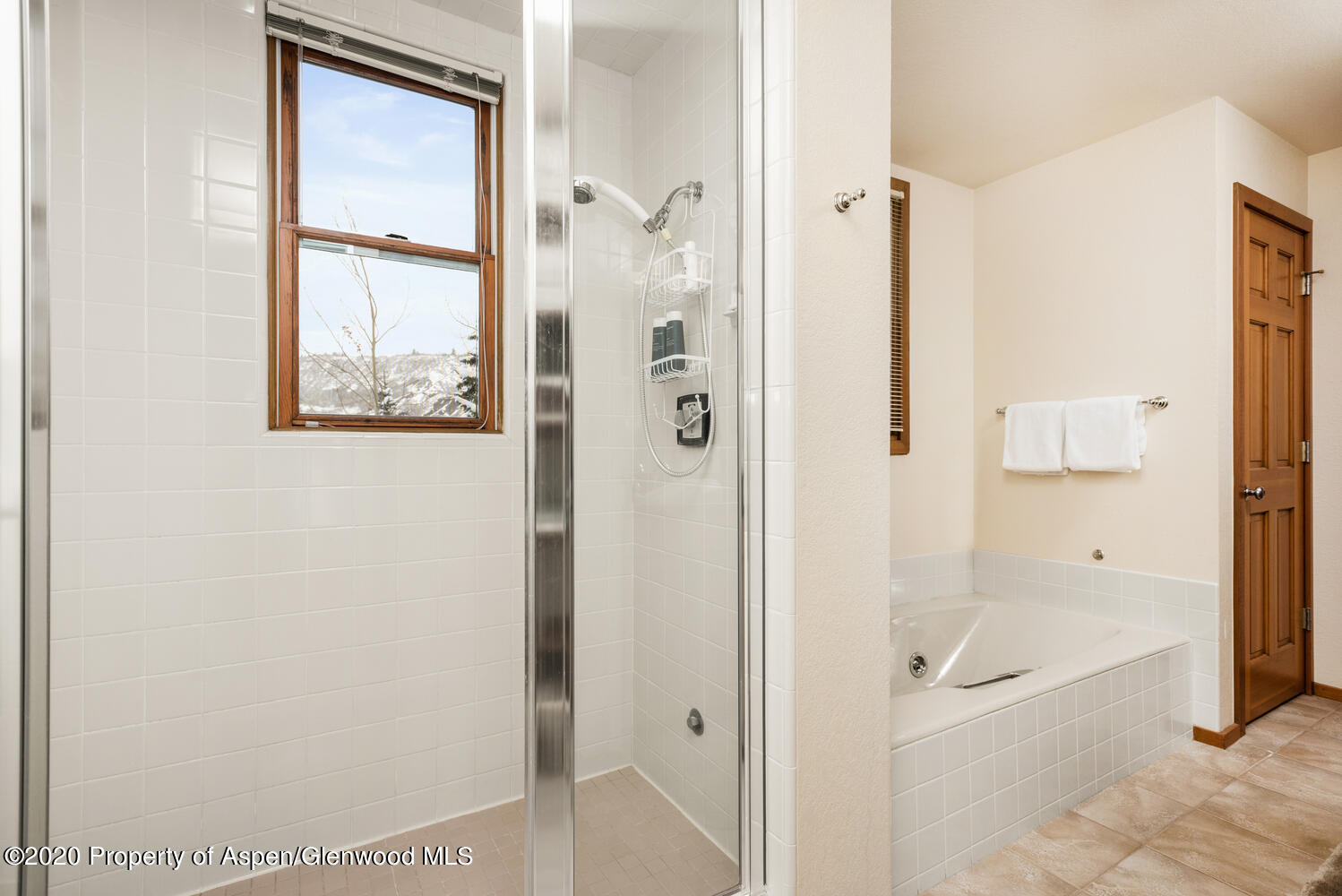 425 Wood Road, Unit 6 Snowmass Village, CO 81615 - Photo 13 of 16 a bathroom with a granite countertop shower mirror and a bathtub