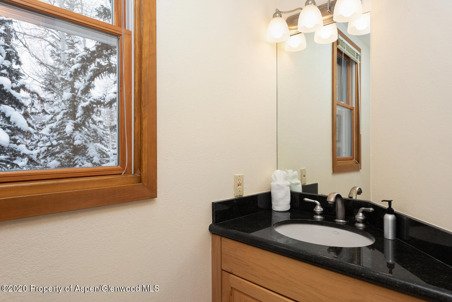 425 Wood Road, Unit 6 Snowmass Village, CO 81615 - Photo 15 of 16 a bathroom with a granite countertop sink and a mirror