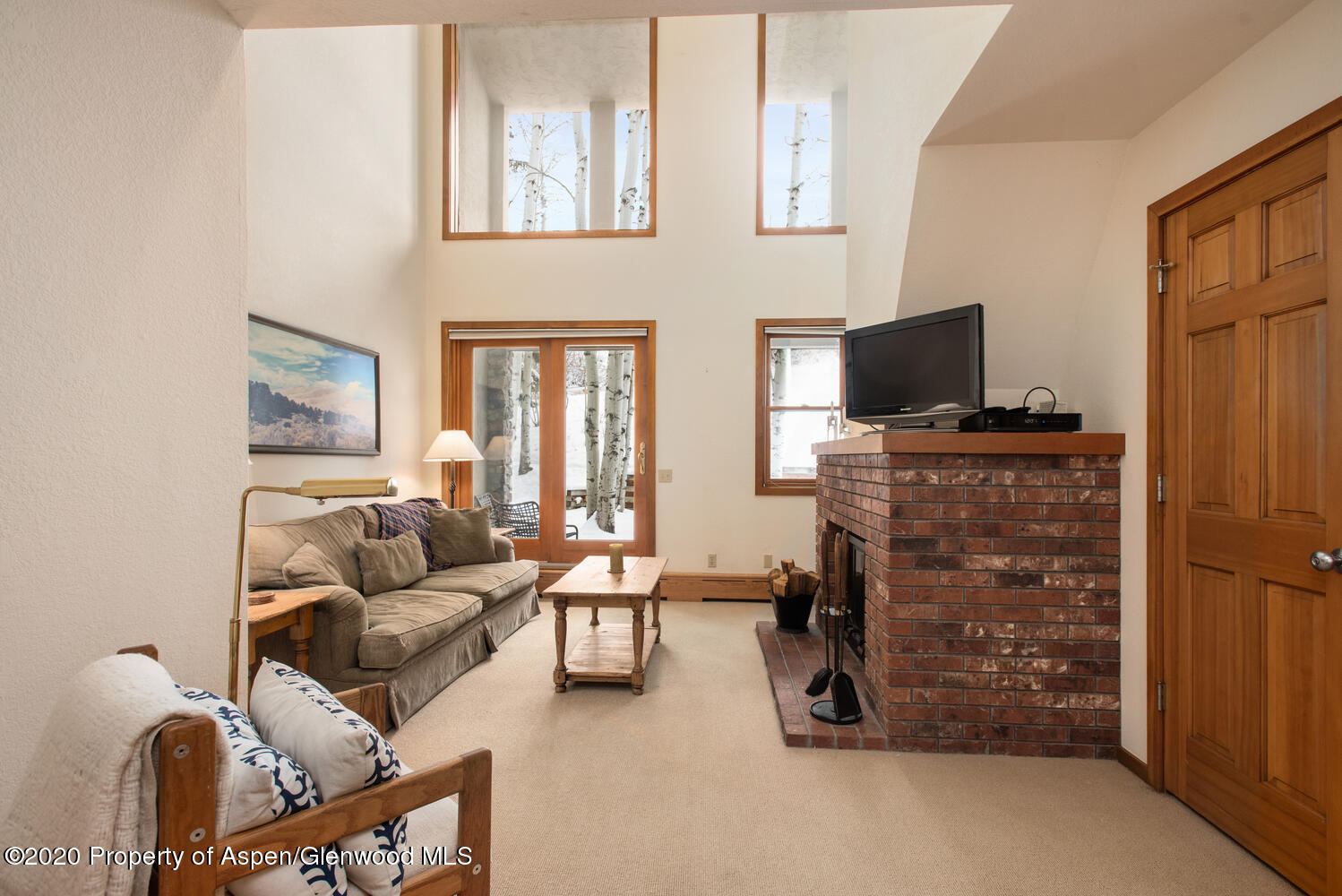 425 Wood Road, Unit 6 Snowmass Village, CO 81615 - Photo 5 of 16 a living room with furniture and a flat screen tv