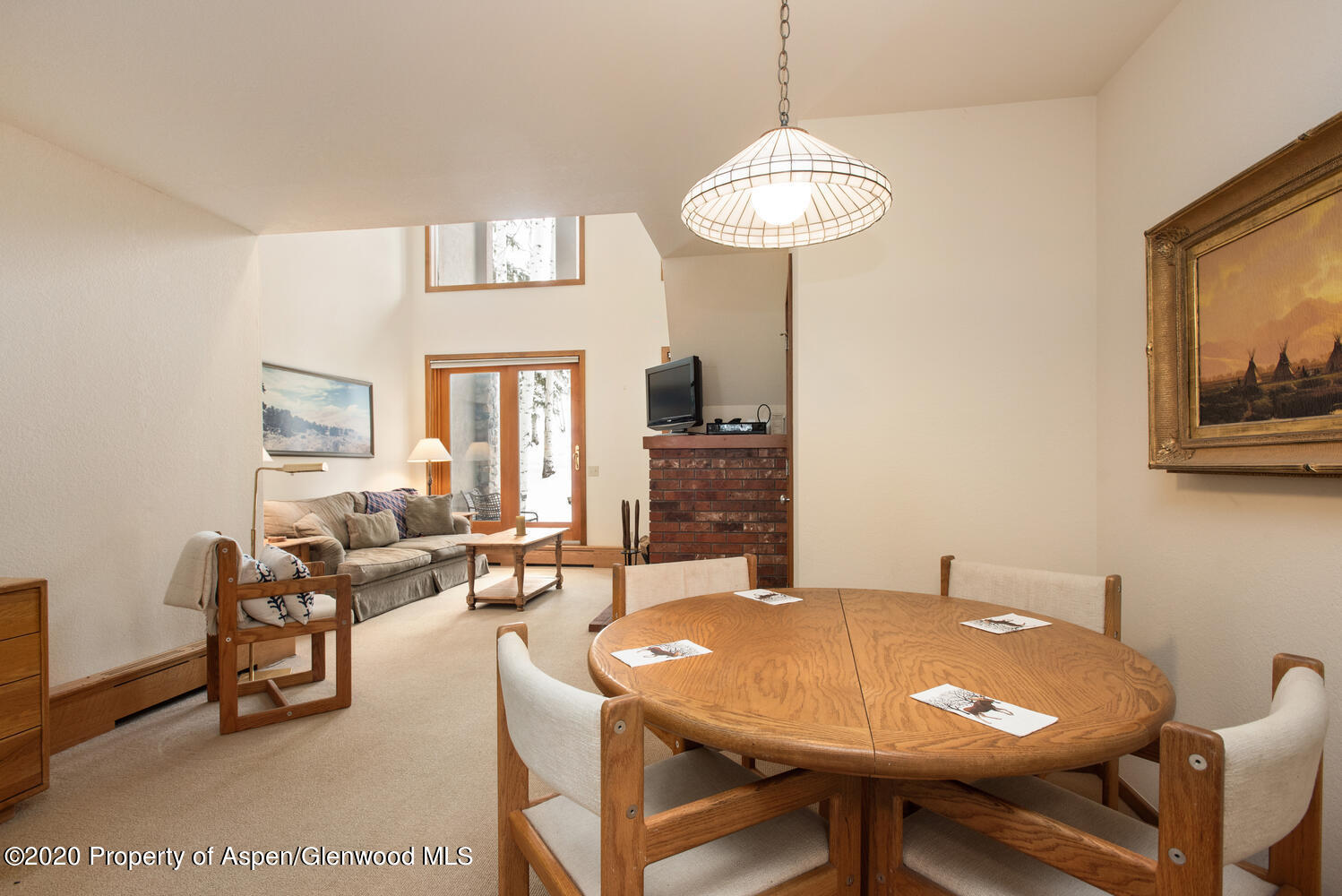 425 Wood Road, Unit 6 Snowmass Village, CO 81615 - Photo 6 of 16 a view of a dining room with furniture a chandelier and wooden floor