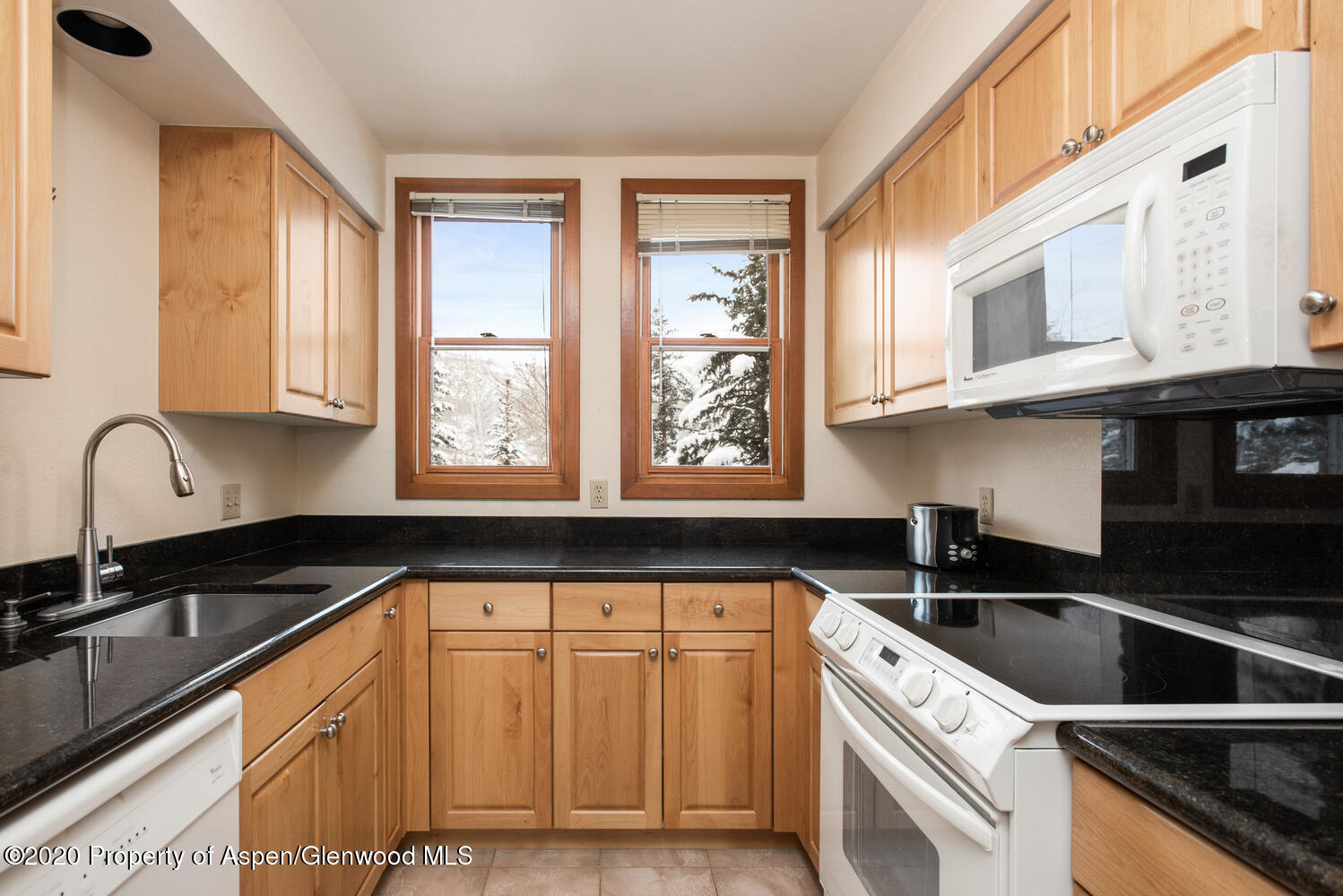 425 Wood Road, Unit 6 Snowmass Village, CO 81615 - Photo 9 of 16 a kitchen with granite countertop a sink a stove and cabinets