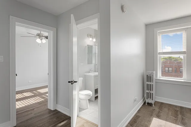 a view of a room with wooden floor and white walls