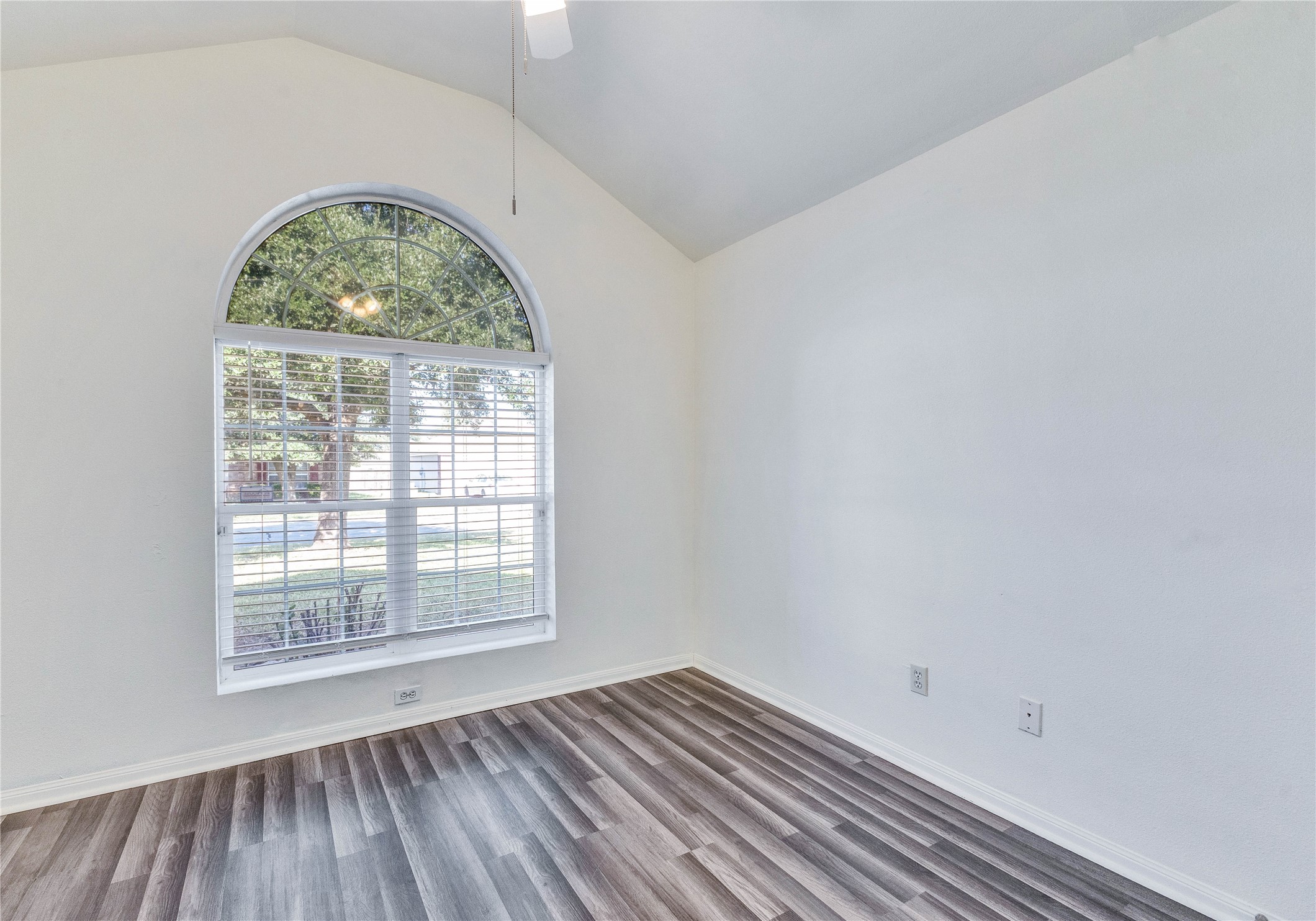 1103 Madison Temple, TX 76504 - Photo 12 of 26 Empty room featuring dark wood finished floors, a ceiling fan, and vaulted ceiling