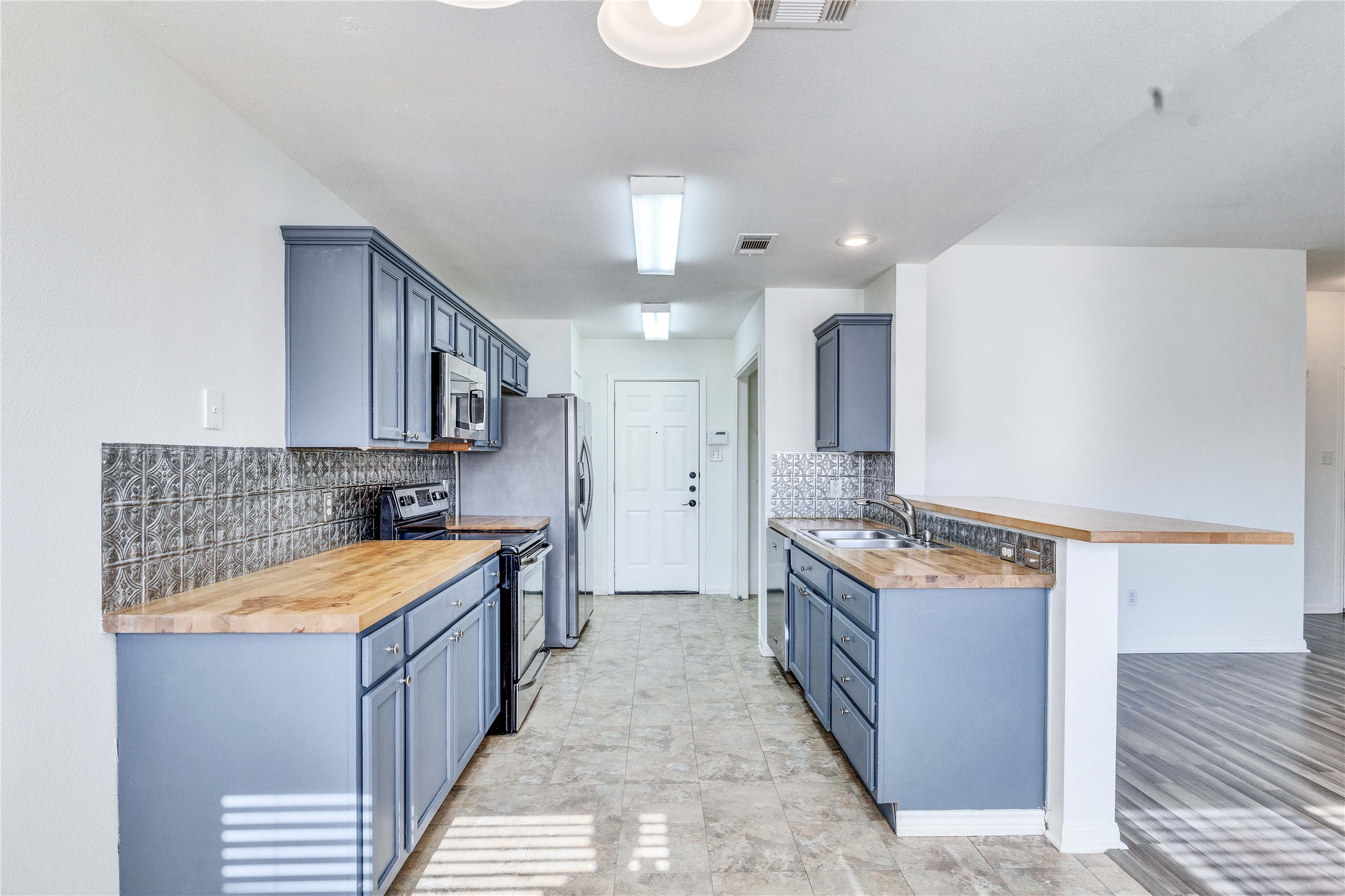 1103 Madison Temple, TX 76504 - Photo 2 of 26 Kitchen featuring wooden counters, stainless steel appliances, a peninsula, and a breakfast bar area