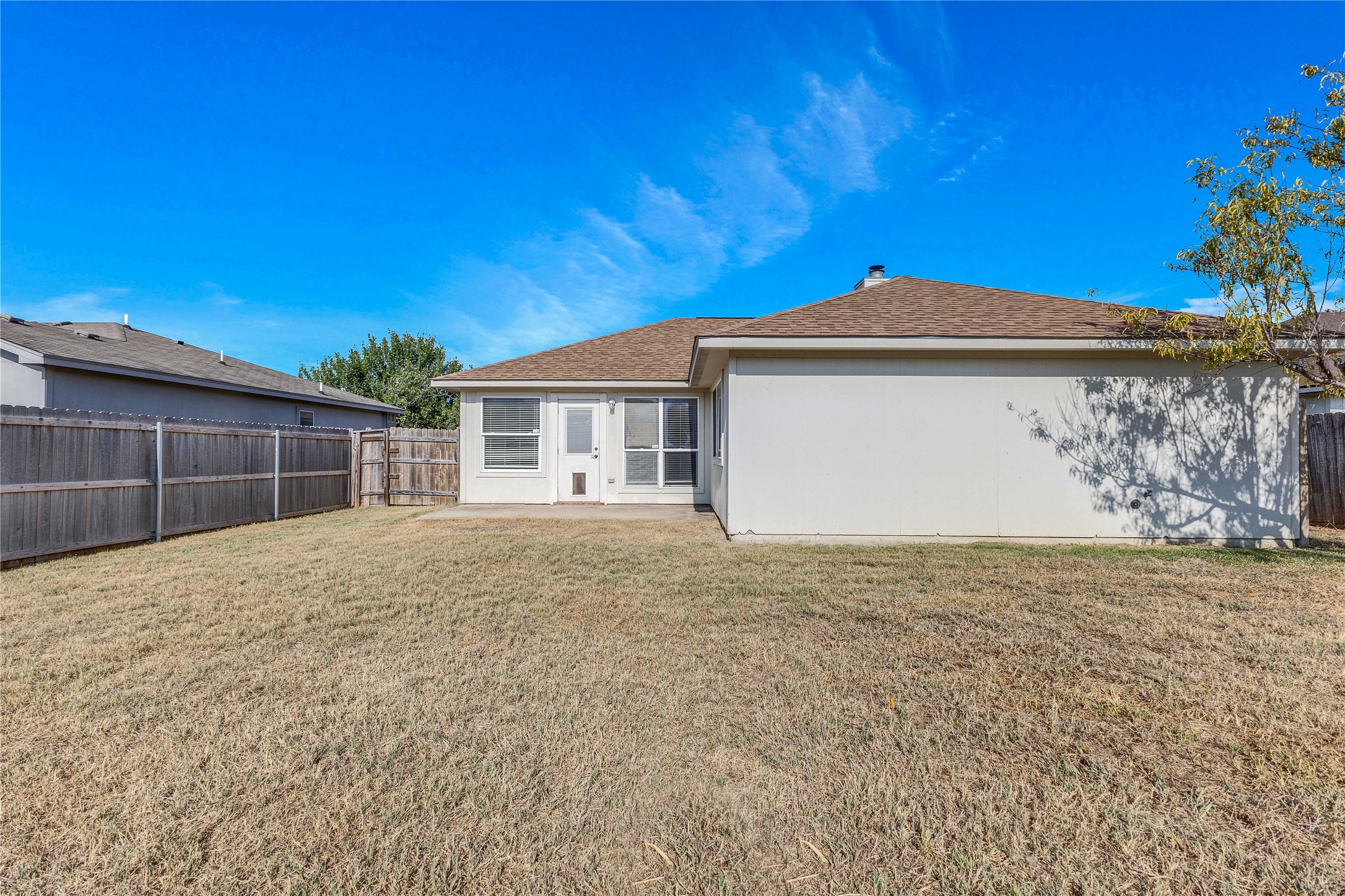1103 Madison Temple, TX 76504 - Photo 20 of 26 Rear view of house featuring a fenced backyard, a shingled roof, and a patio area