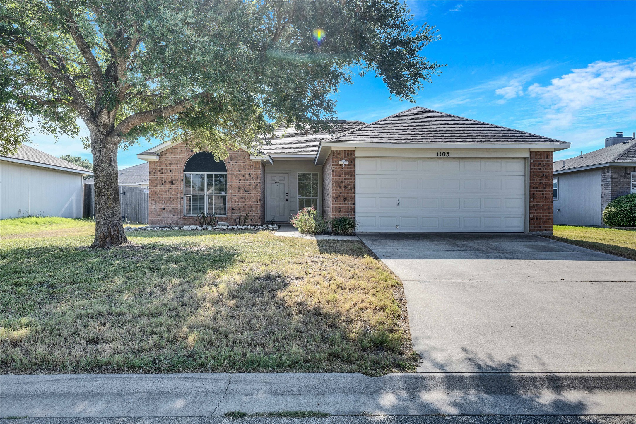 1103 Madison Temple, TX 76504 - Photo 21 of 26 Ranch-style house with brick siding, a garage, concrete driveway, and roof with shingles