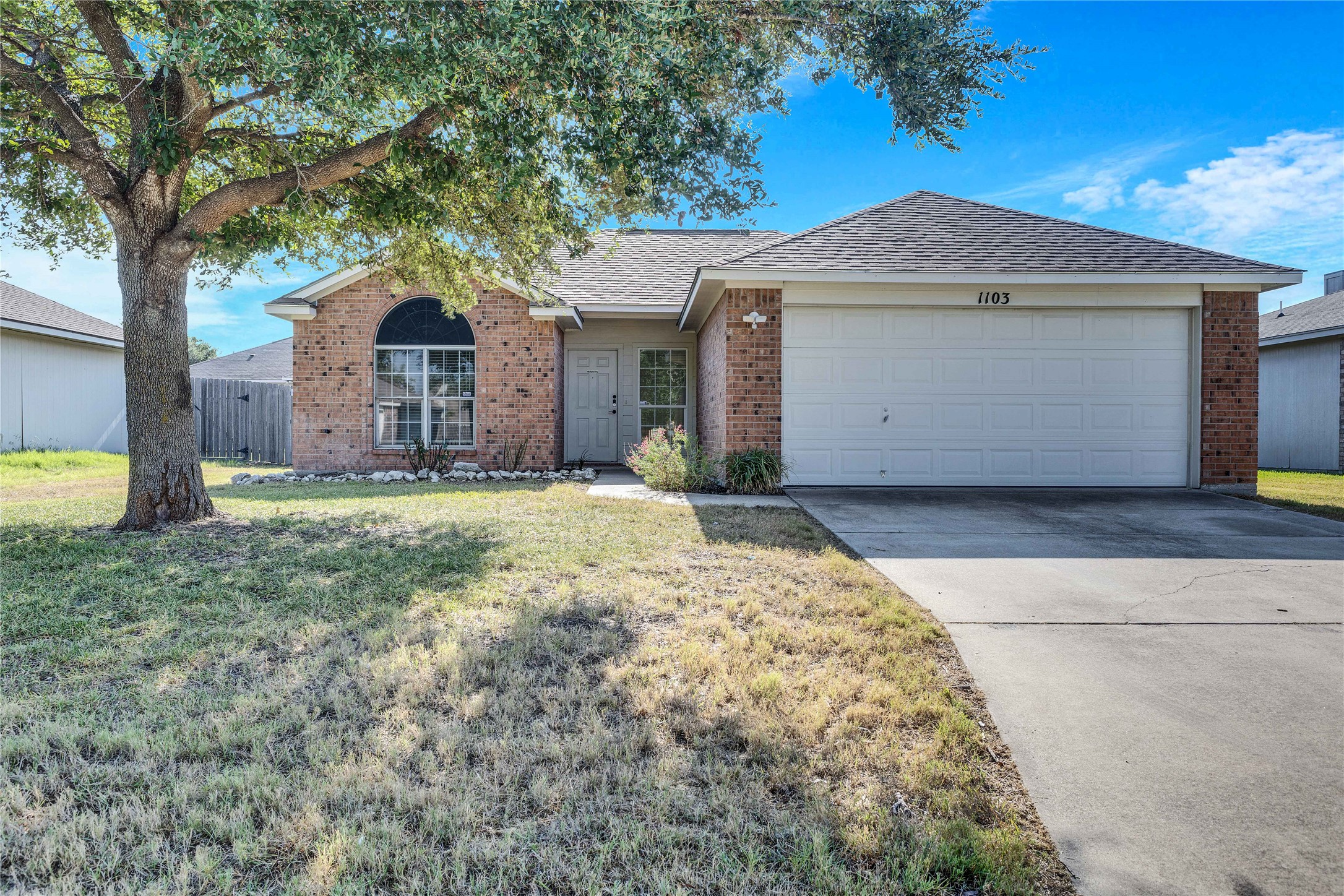 1103 Madison Temple, TX 76504 - Photo 22 of 26 Single story home with brick siding, roof with shingles, concrete driveway, and an attached garage