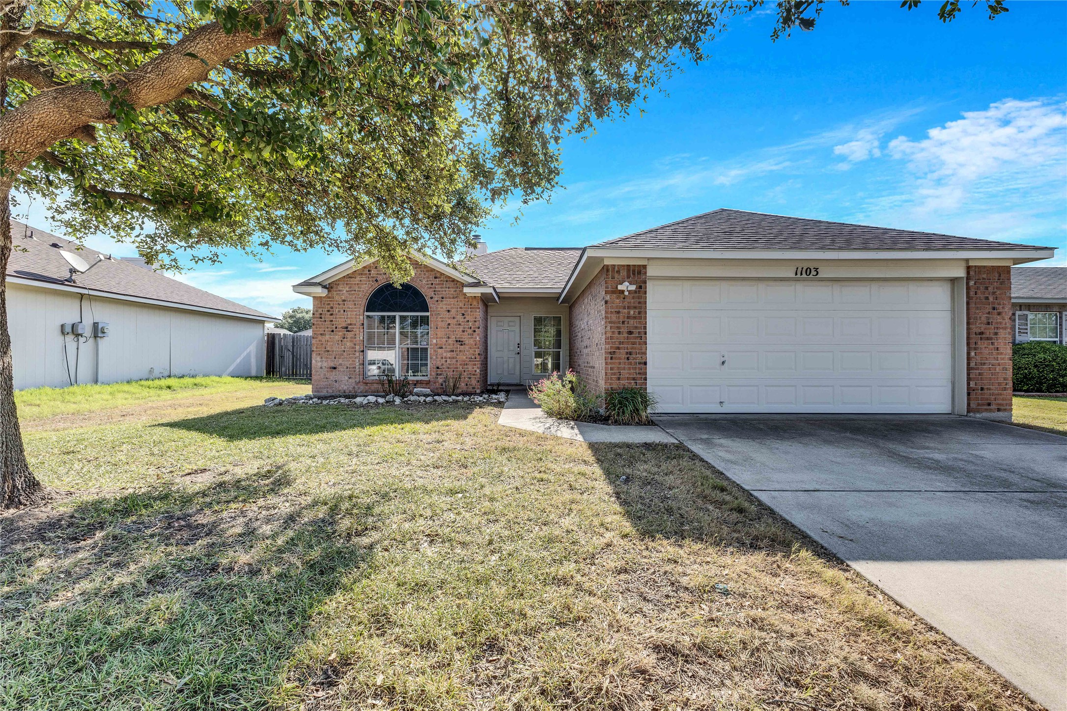 1103 Madison Temple, TX 76504 - Photo 23 of 26 Ranch-style house featuring brick siding, concrete driveway, an attached garage, and roof with shingles