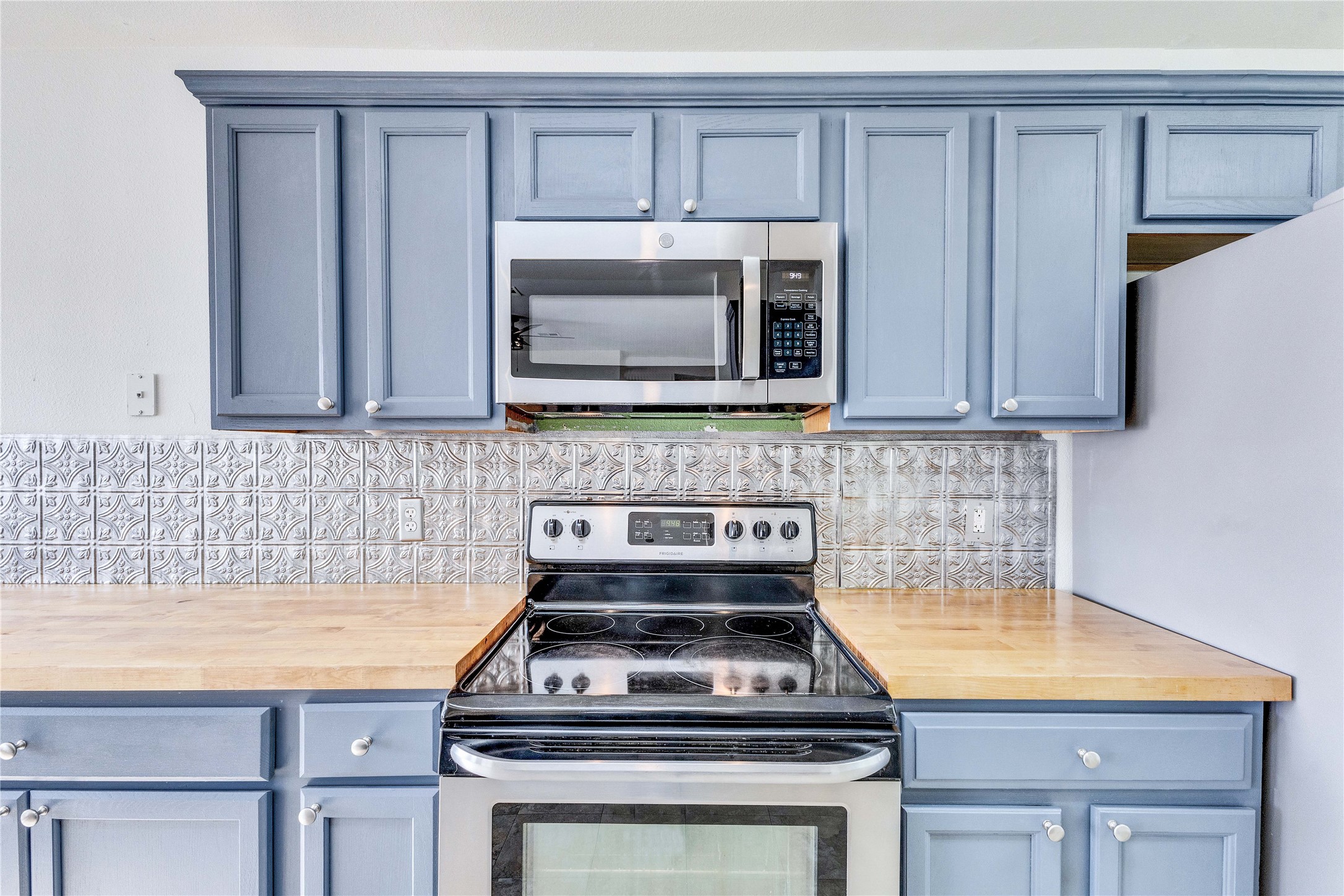 1103 Madison Temple, TX 76504 - Photo 5 of 26 Kitchen with stainless steel appliances, butcher block countertops, backsplash, and blue cabinets