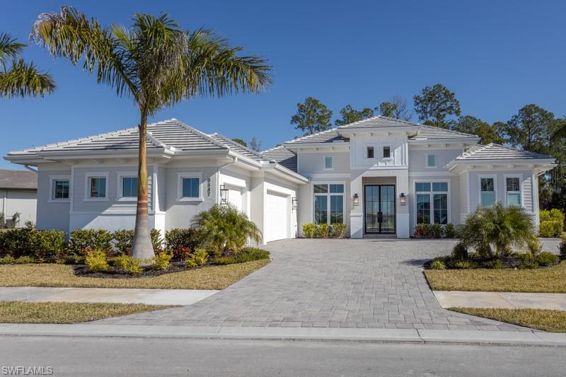 9587 Caymas Way Naples, FL 34114 - Photo 1 of 7 front view of a house with a yard