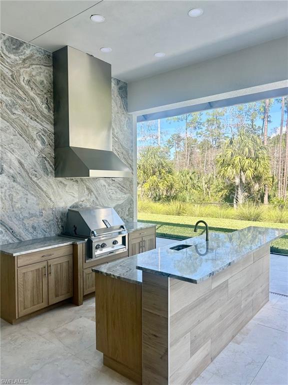 9587 Caymas Way Naples, FL 34114 - Photo 4 of 7 a kitchen with stainless steel appliances granite countertop a sink and a wooden cabinets