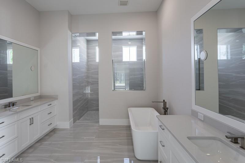 9587 Caymas Way Naples, FL 34114 - Photo 7 of 7 a bathroom with a double vanity sink mirror and toilet