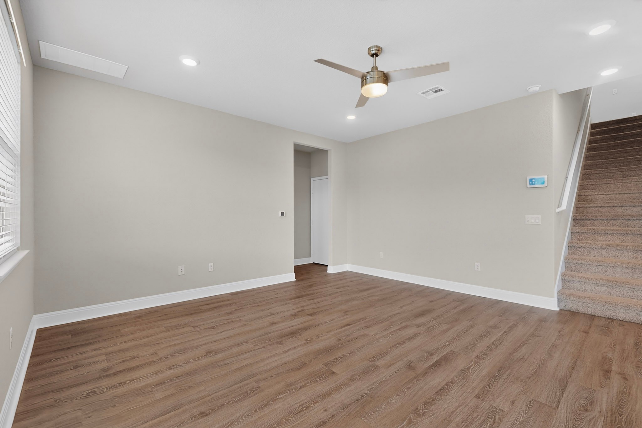 16809 Guido Cove Pflugerville, TX 78660 - Photo 6 of 40 Spacious room featuring wood-finish flooring, recessed lighting, and a ceiling fan