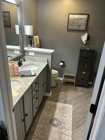 a bathroom with a sink a mirror and a toilet