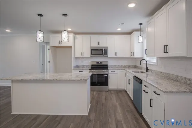 a kitchen with stainless steel appliances granite countertop a sink a stove and a granite counter tops