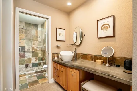 a bathroom with a granite countertop sink mirror and vanity