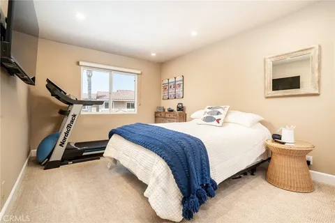 a living room with furniture a flat screen tv and a window