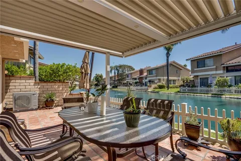a view of a house with a yard balcony and sitting area