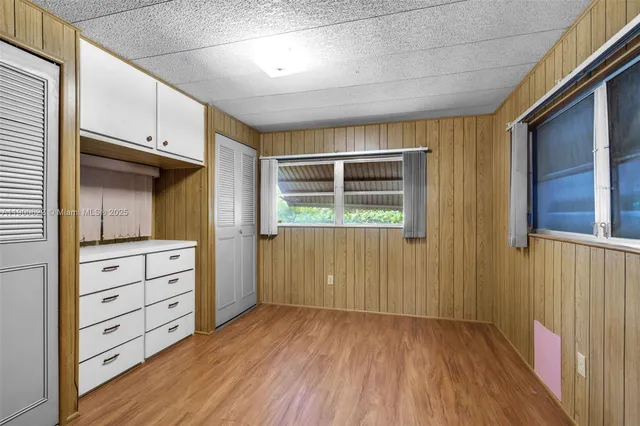 a view of walk in closet with wooden floor