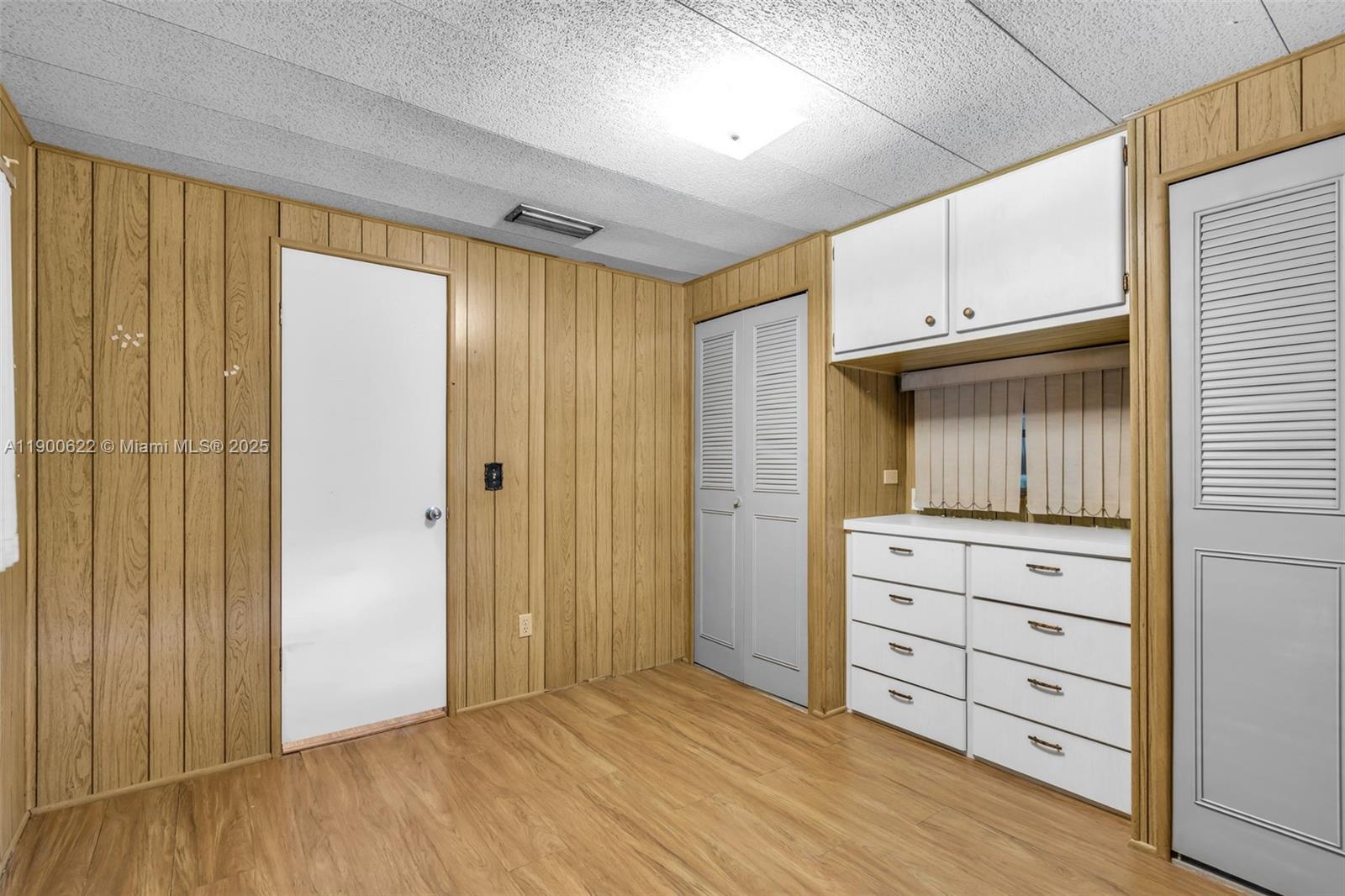 8360 Southwest 21st Street Davie, FL 33324 - Photo 14 of 33 a view of walk in closet with hardwood