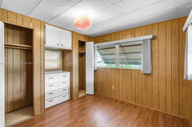 a view of walk in closet with wooden floor
