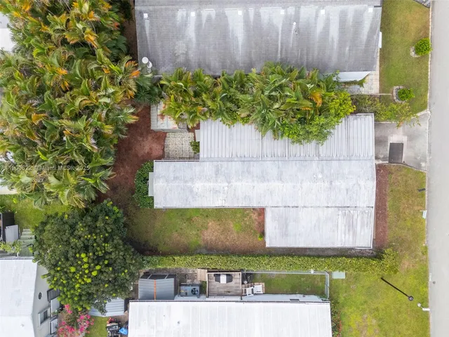 an aerial view of residential houses with outdoor space and ocean view