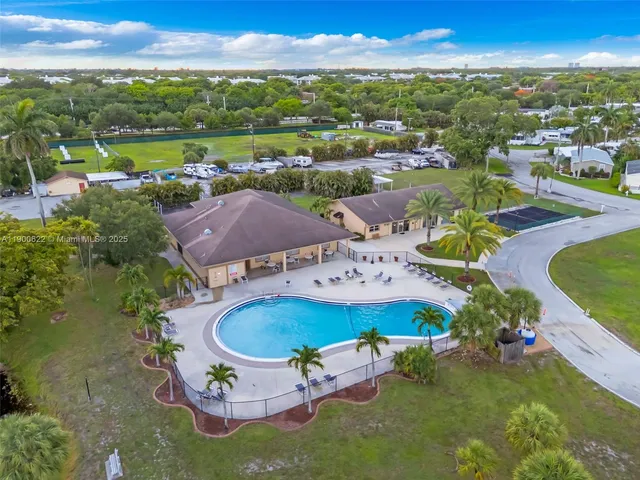 an aerial view of a house with garden space and ocean view