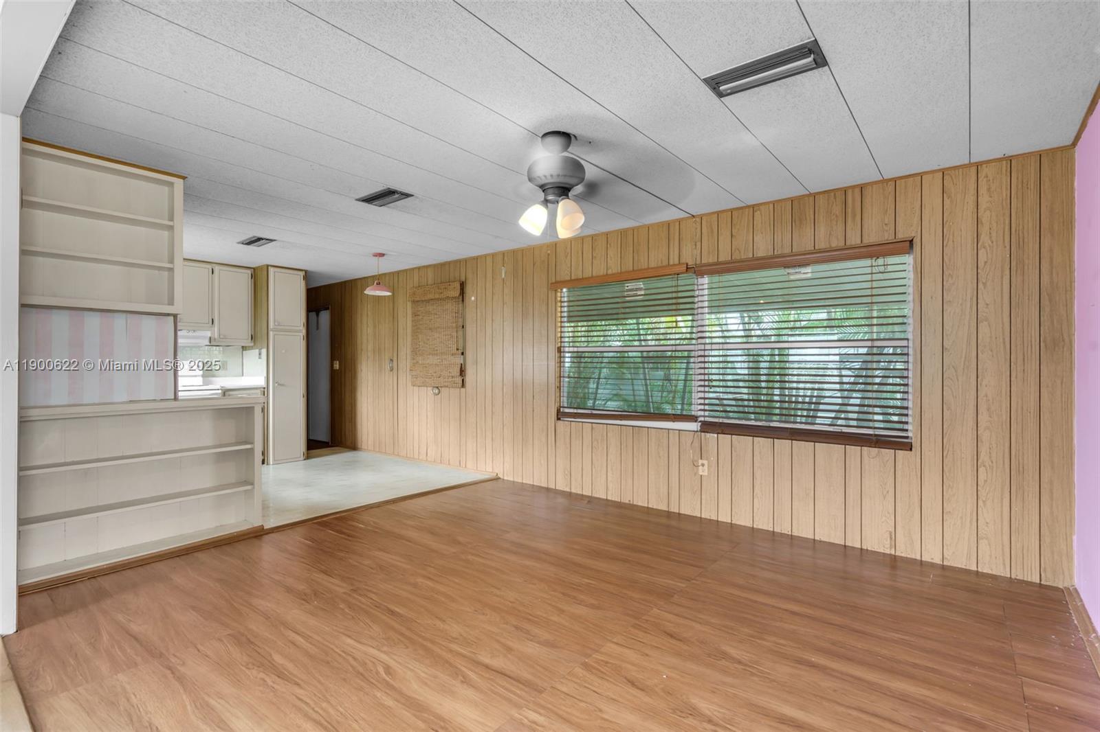 8360 Southwest 21st Street Davie, FL 33324 - Photo 6 of 33 a view of an empty room with wooden floor and a window