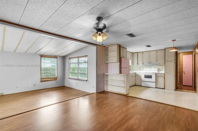 a view of a kitchen with stove and cabinets
