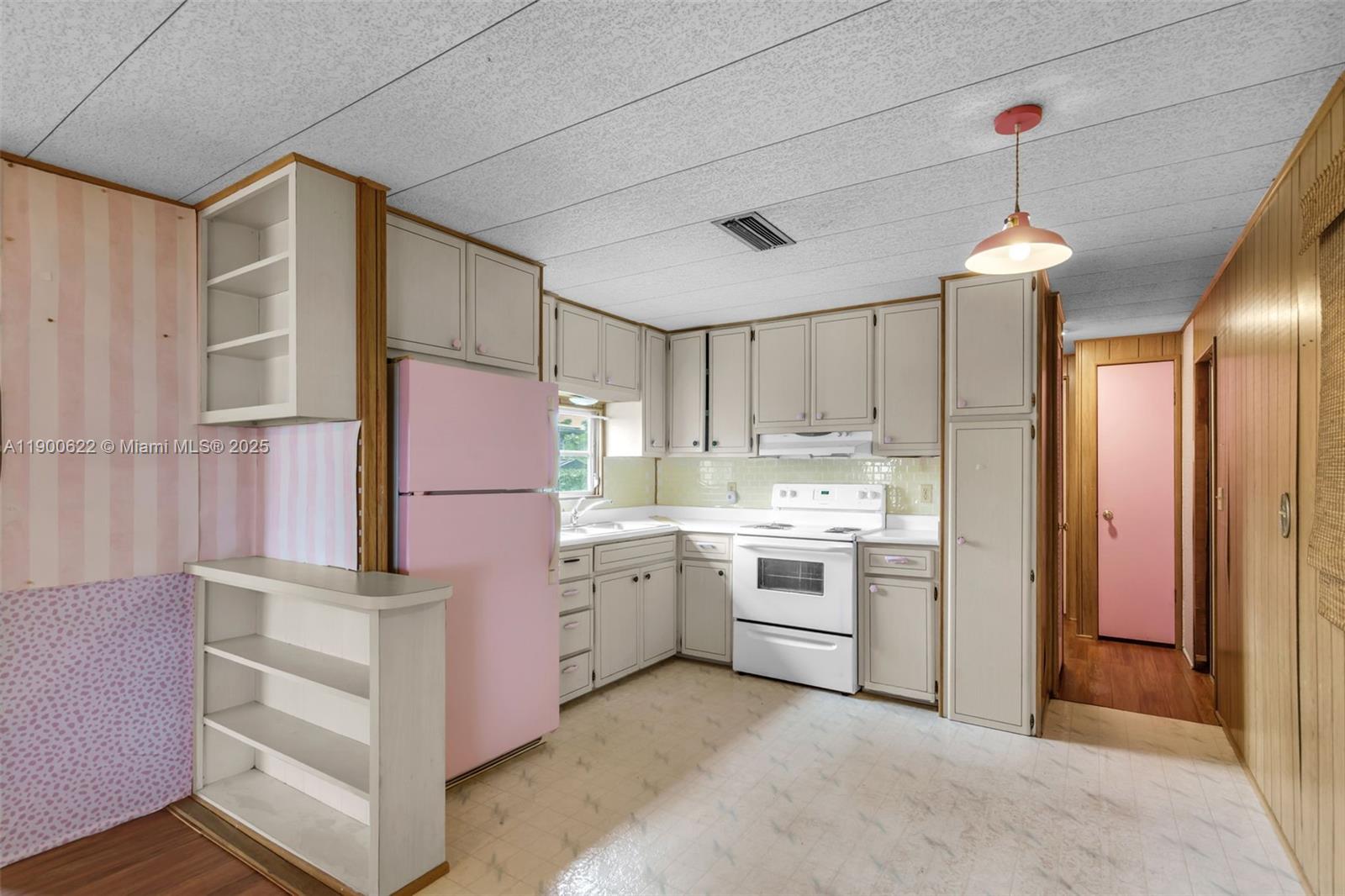 8360 Southwest 21st Street Davie, FL 33324 - Photo 8 of 33 a kitchen that has a lot of white cabinets and stainless steel appliances
