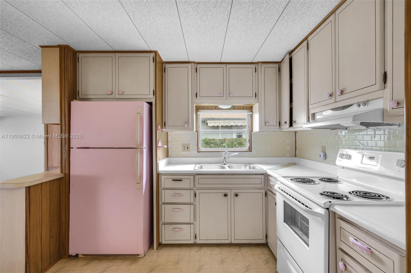 8360 Southwest 21st Street Davie, FL 33324 - Photo 9 of 33 a kitchen with a sink a stove a refrigerator and cabinets