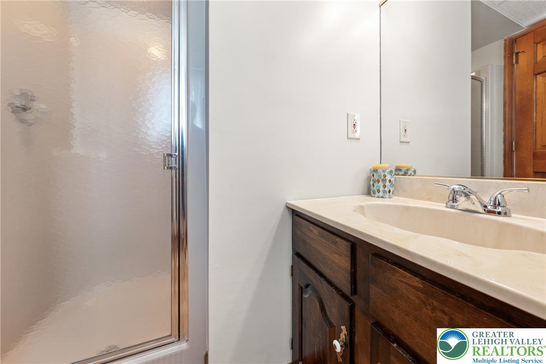 947 Tamenend Road Bath, PA 18014 - Photo 9 of 61 A streamlined vanity with integrated sink and chrome fixtures offers utility in this compact bathing area.