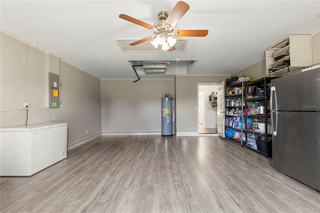 9917 Nelson Road Dade City, FL 33525 - Photo 23 of 40 a view of an empty room with a window and wooden floor
