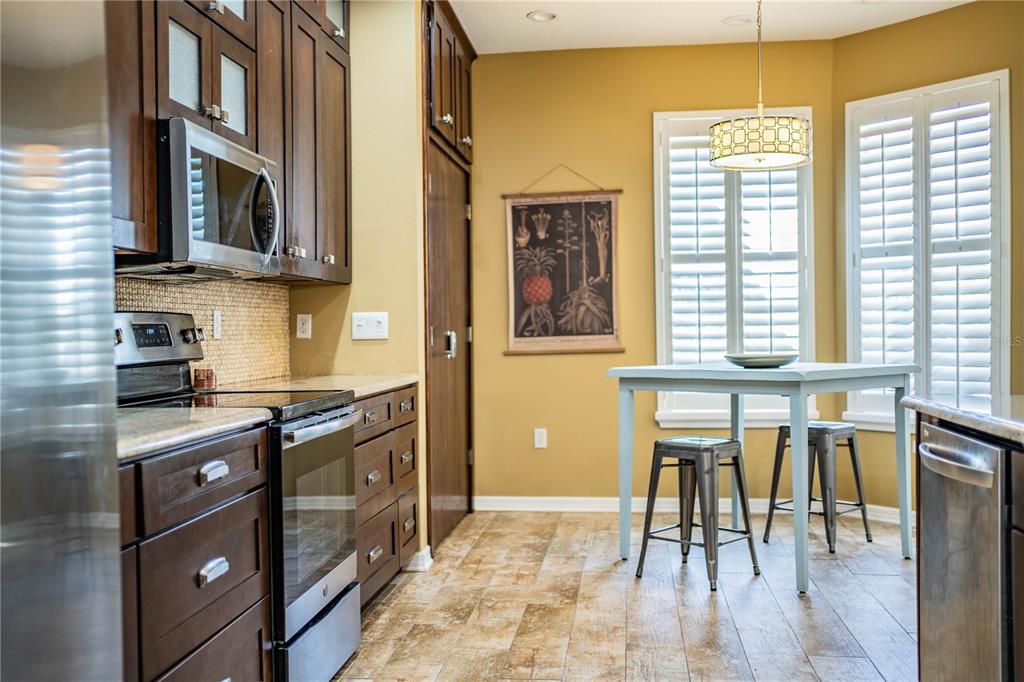 3234 Stonebridge Trail Valrico, FL 33596 - Photo 15 of 34 a kitchen with stainless steel appliances granite countertop a stove and a refrigerator