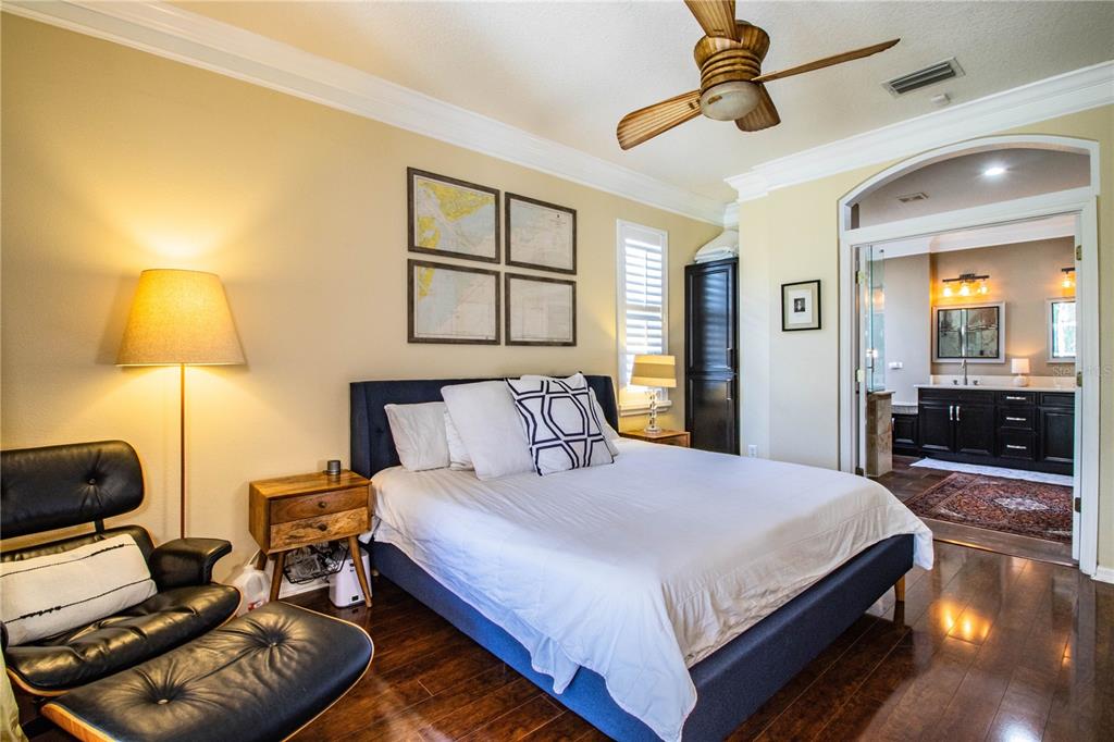 3234 Stonebridge Trail Valrico, FL 33596 - Photo 18 of 34 a bedroom with a bed and wooden floor