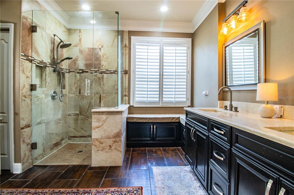 3234 Stonebridge Trail Valrico, FL 33596 - Photo 21 of 34 a bathroom with a granite countertop sink a toilet a mirror and shower