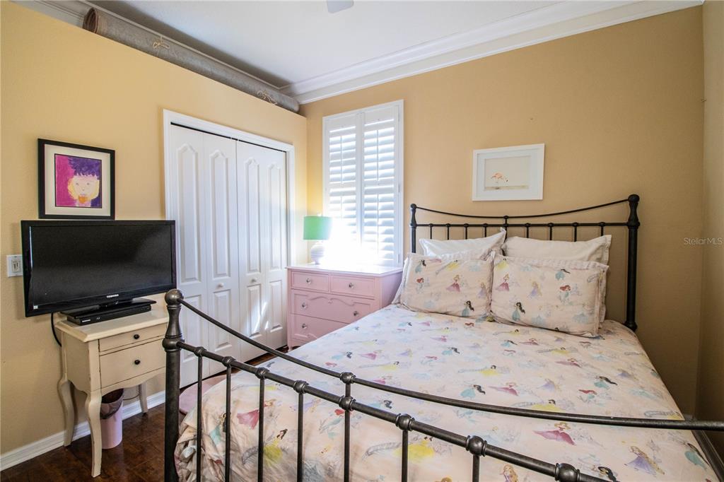 3234 Stonebridge Trail Valrico, FL 33596 - Photo 22 of 34 a bedroom with a bed and a flat screen tv