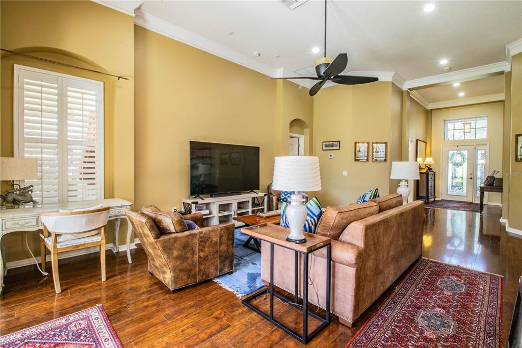 3234 Stonebridge Trail Valrico, FL 33596 - Photo 5 of 34 a living room with furniture ceiling fan and a flat screen tv