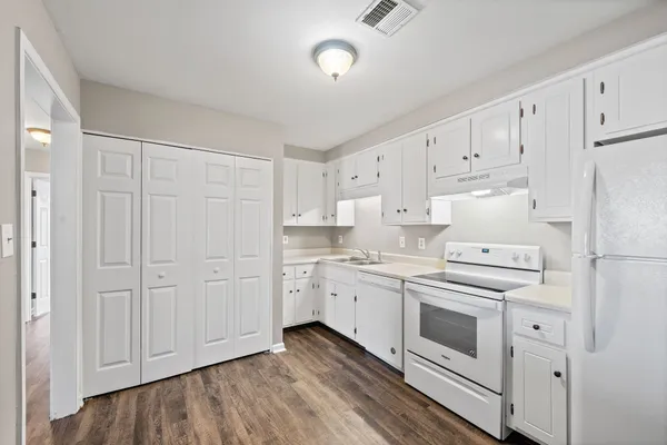 a kitchen with cabinets stainless steel appliances and sink
