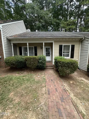 a view of a house with a yard and plants