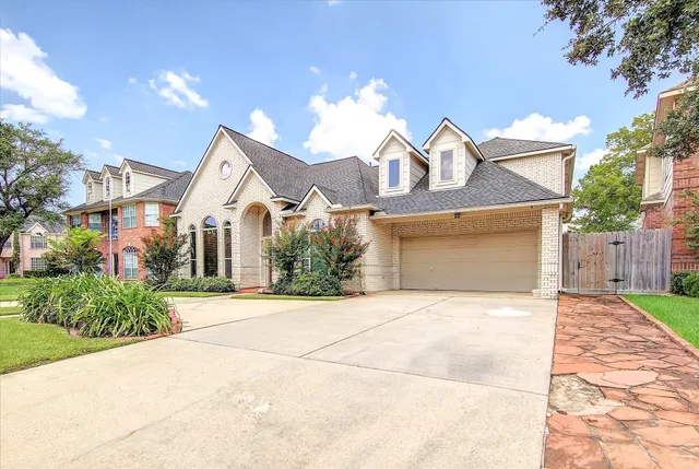 a front view of a house with yard and a garage