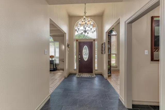 a view of a hallway with windows chandelier