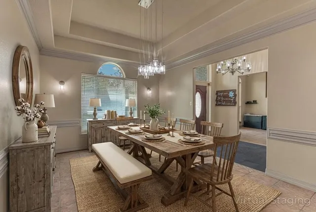 a view of a dining room with furniture and chandelier