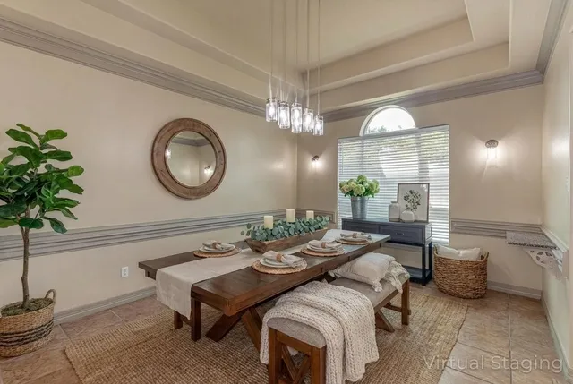a living room with furniture a mirror and a chandelier
