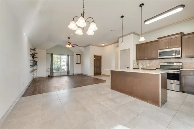 a view of a kitchen with a sink and refrigerator