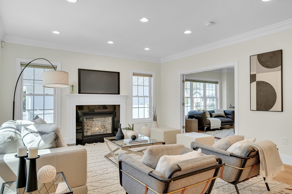 19 Bryn Mawr Road Wellesley, MA 02482 - Photo 11 of 42 a living room with furniture a fireplace and a flat screen tv