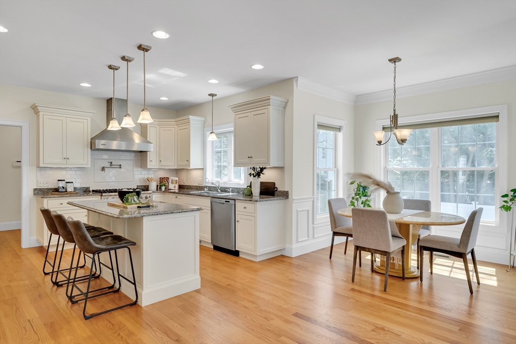 19 Bryn Mawr Road Wellesley, MA 02482 - Photo 17 of 42 a kitchen with kitchen island stainless steel appliances a dining table and chairs