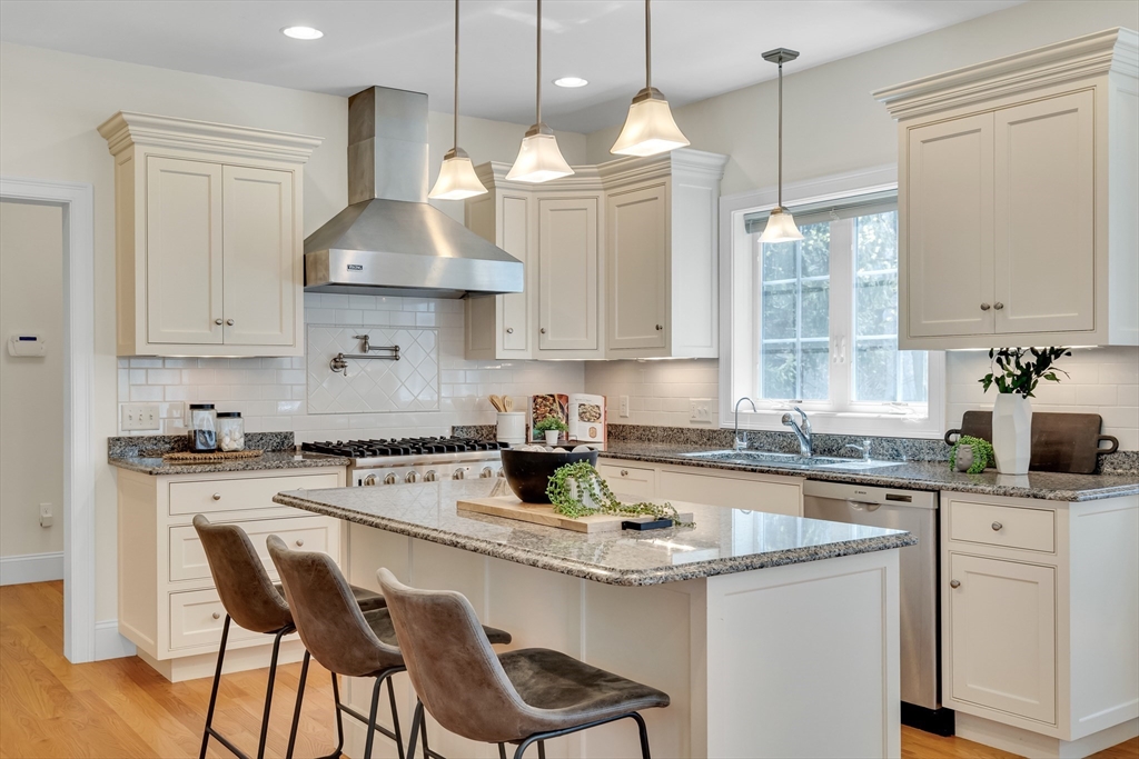 19 Bryn Mawr Road Wellesley, MA 02482 - Photo 18 of 42 a kitchen with stainless steel appliances granite countertop a sink a stove a refrigerator and island